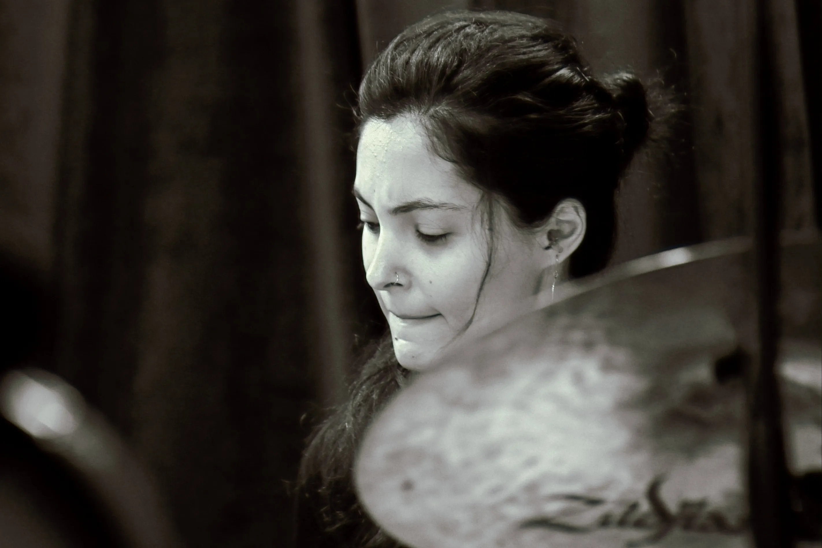 Rosina playing drums in black and white